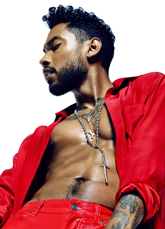 Miguel poses in a red outfit for official artwork from Sony.