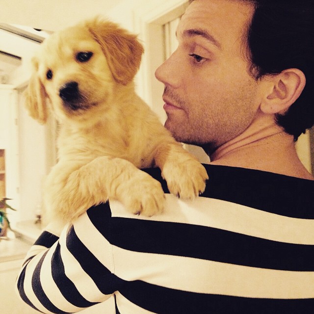 Pictured in a striped sweater, Mika shares an image of his new pup. 