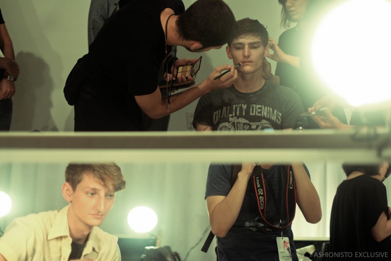 Models getting their makeup done for Perry Ellis' spring-summer 2016 menswear show.