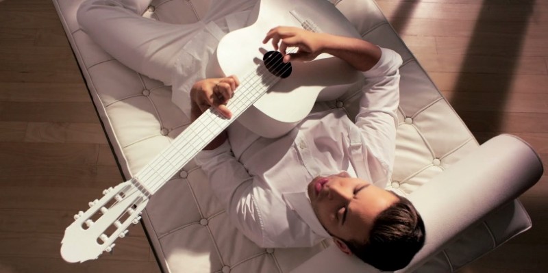 Prince Royce is chic in a Alexander McQueen harness shirt with white jeans and even a white guitar.