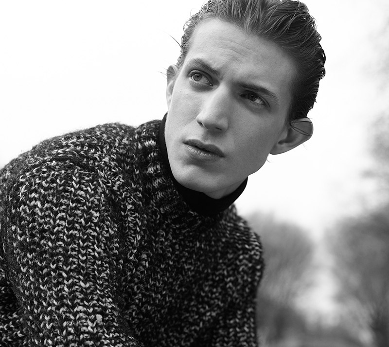 Xavier Buestel models a black and white marle knit sweater for Sandro's fall-winter 2015 advertising campaign.