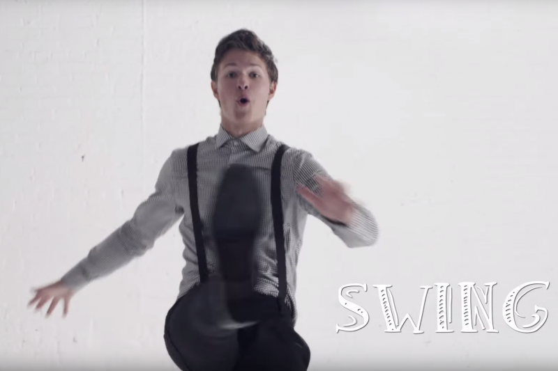 Ansel Elgort kicks his leg up high as he performs a Swing dance.