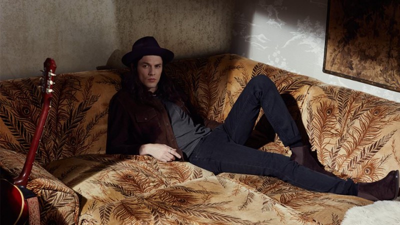 Sporting a Billy Reid suede workshirt with Paul Smith chelsea boots, James Bay completes his look with a jersey t-shirt and denim jeans from Saint Laurent.