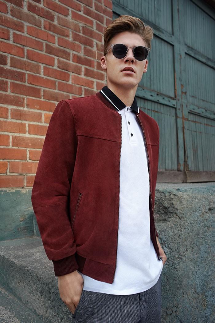 Mikkel Jensen embraces the bomber jacket trend in a rich burgundy.