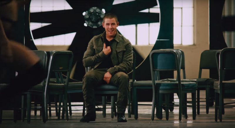 Nick Jonas goes monochromatic in an army green look for his Levels music video.