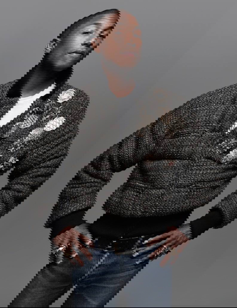 Pharrell Williams pours on the embellishments, donning a bomber jacket with pins and brooches. 