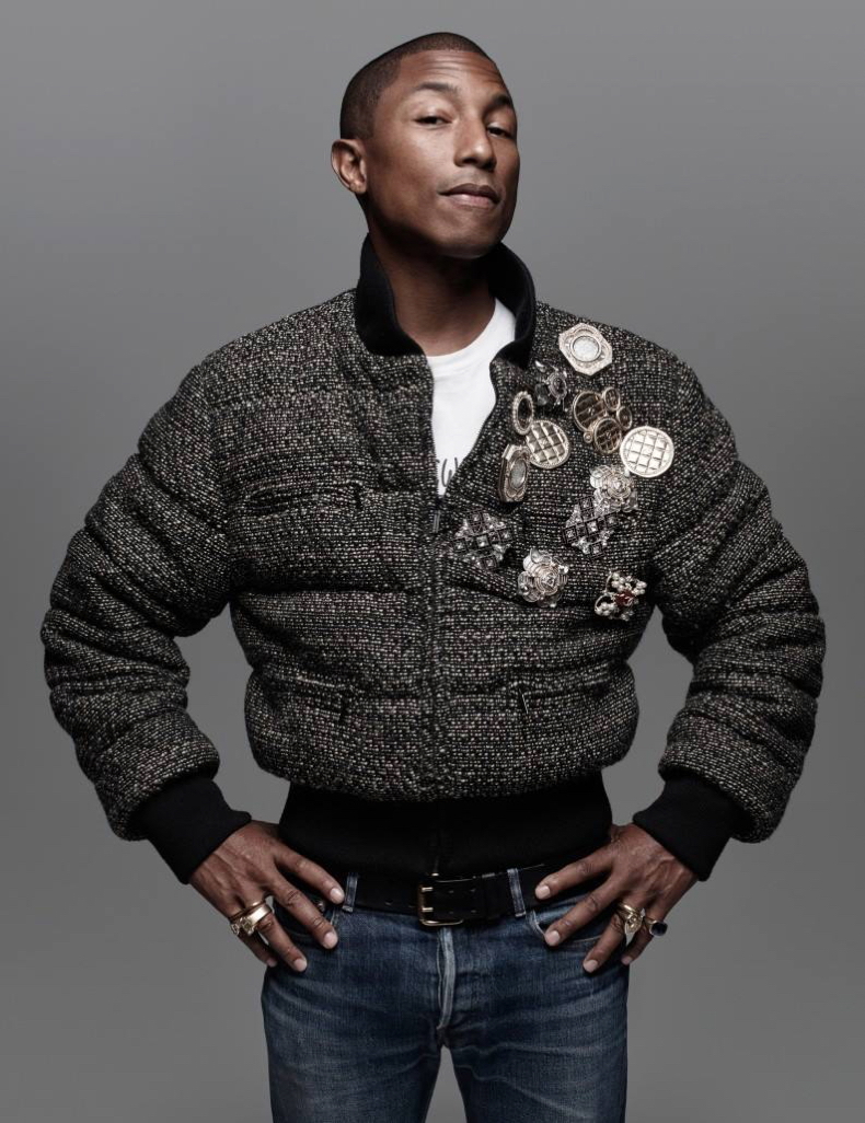 Pharrell Williams pours on the embellishments, donning a bomber jacket with pins and brooches. 