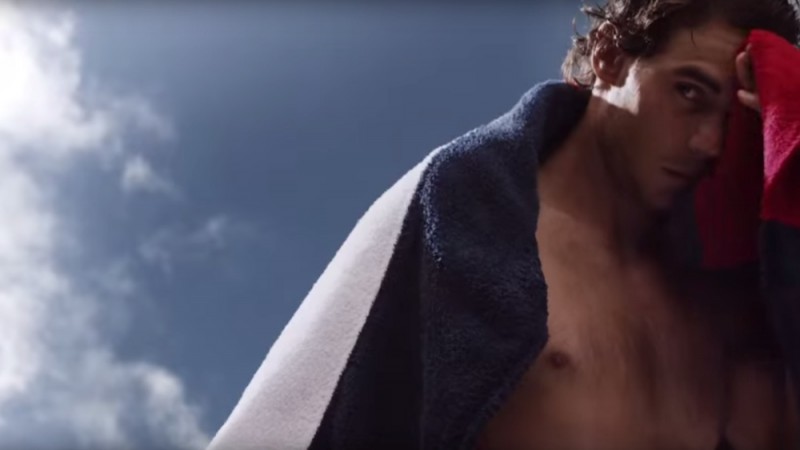 Rafael Nadal wraps up in an iconic red, white and blue Tommy Hilfiger towel.