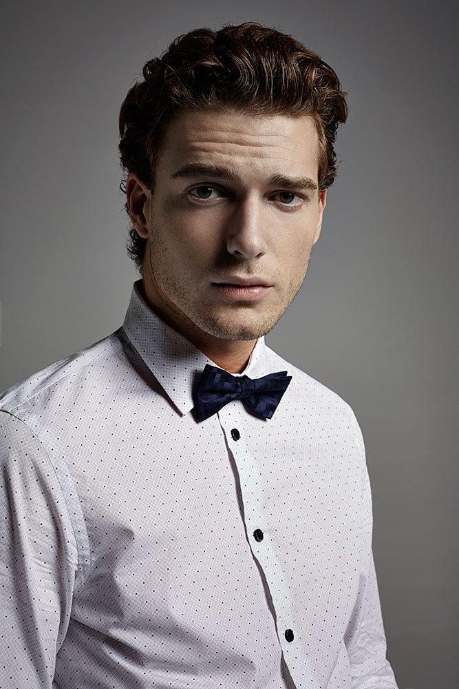 Nikola Jovanovic sports a charming bow-tie with a printed dress shirt.