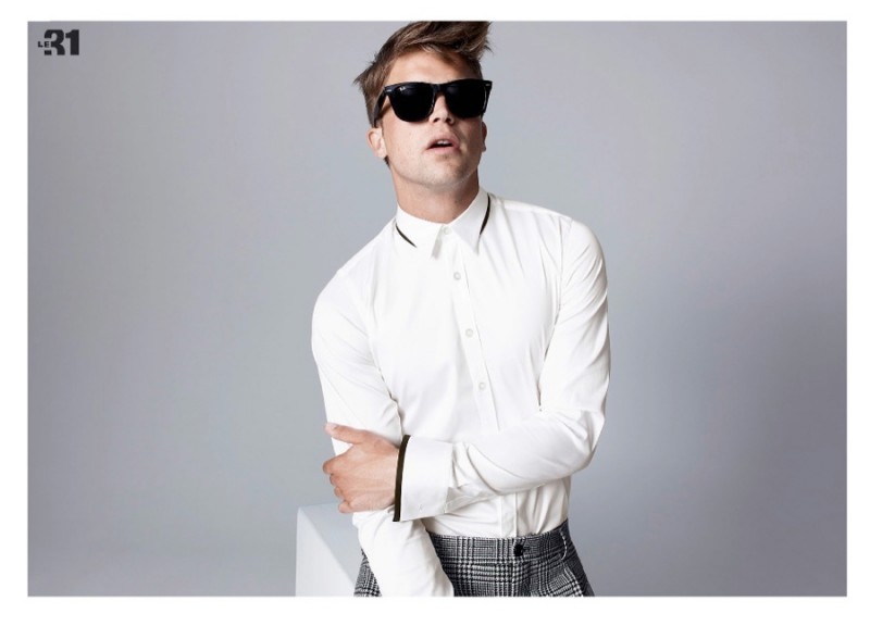 River Viiperi is cool in shades as he dons a smart dress shirt and houndstooth print trousers.