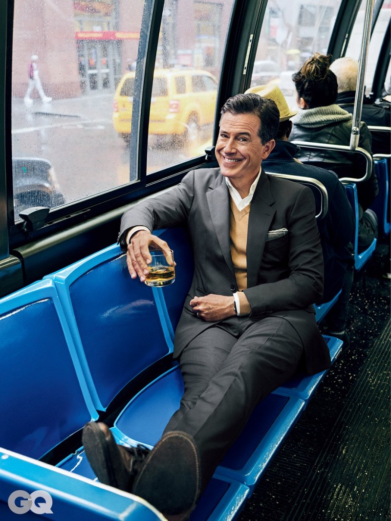 Stephen Colbert enjoys a drink as he rides the bus.