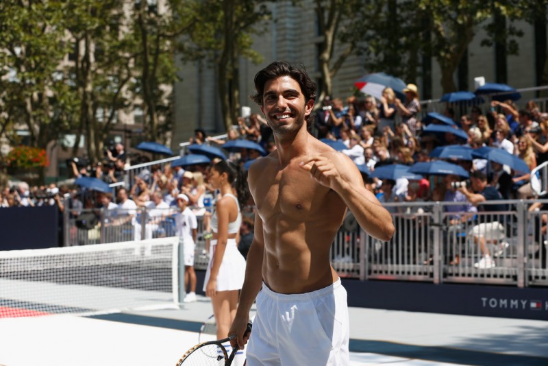 Fitness model Akin Akman plays tennis.