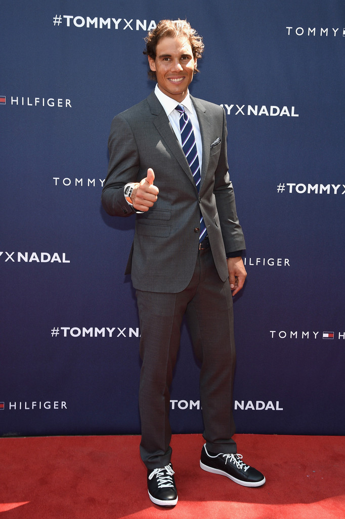 Rafael Nadal hits the red carpet in Tommy Hilfiger Tailoring, finishing his suiting look with sneakers.