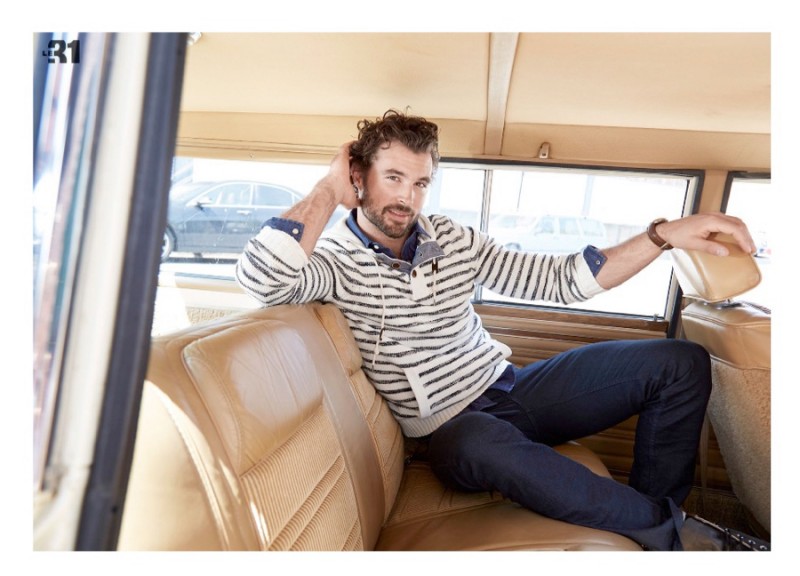 Walter Savage embraces stripes as he poses in the back of a vintage station wagon.