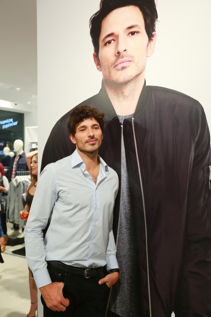 Andres Velencoso Segura poses next to an enlarged ad image of him at Joe Fresh's new store in Mexico City.