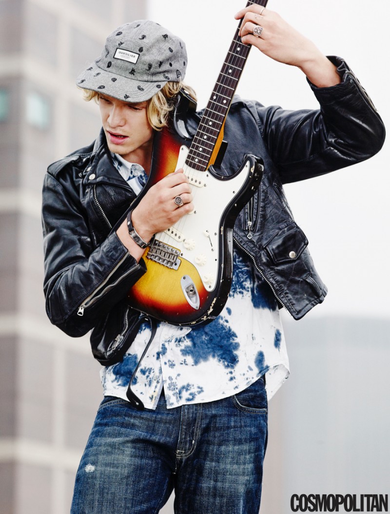 Cody Simpson poses for a Cosmopolitan picture with a guitar.