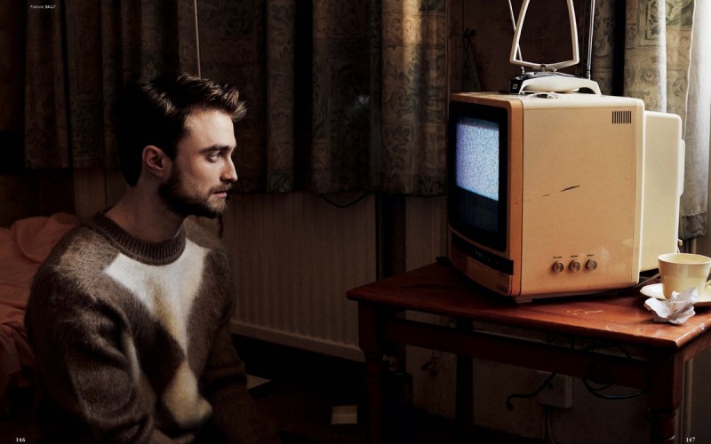 Daniel Radcliffe watches the tube in a Bally sweater.