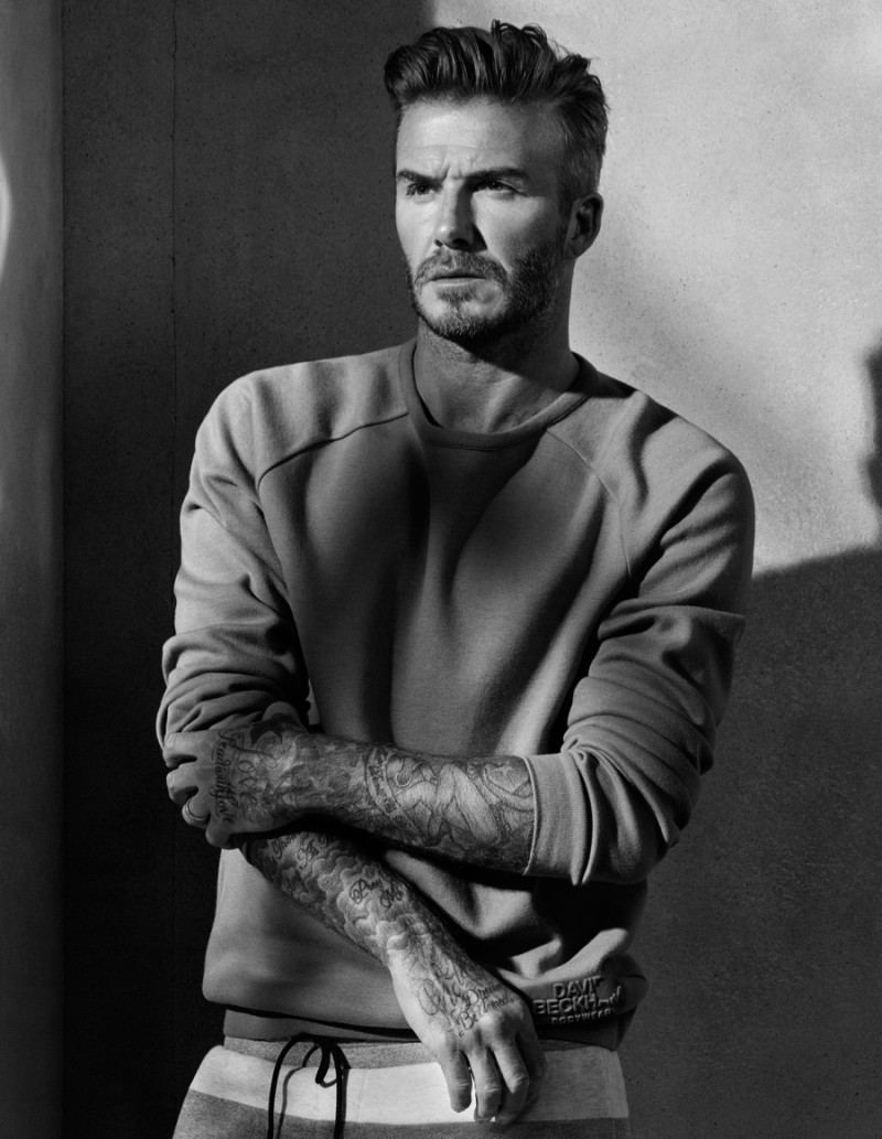 David Beckham poses for a moody image in a pullover and joggers.