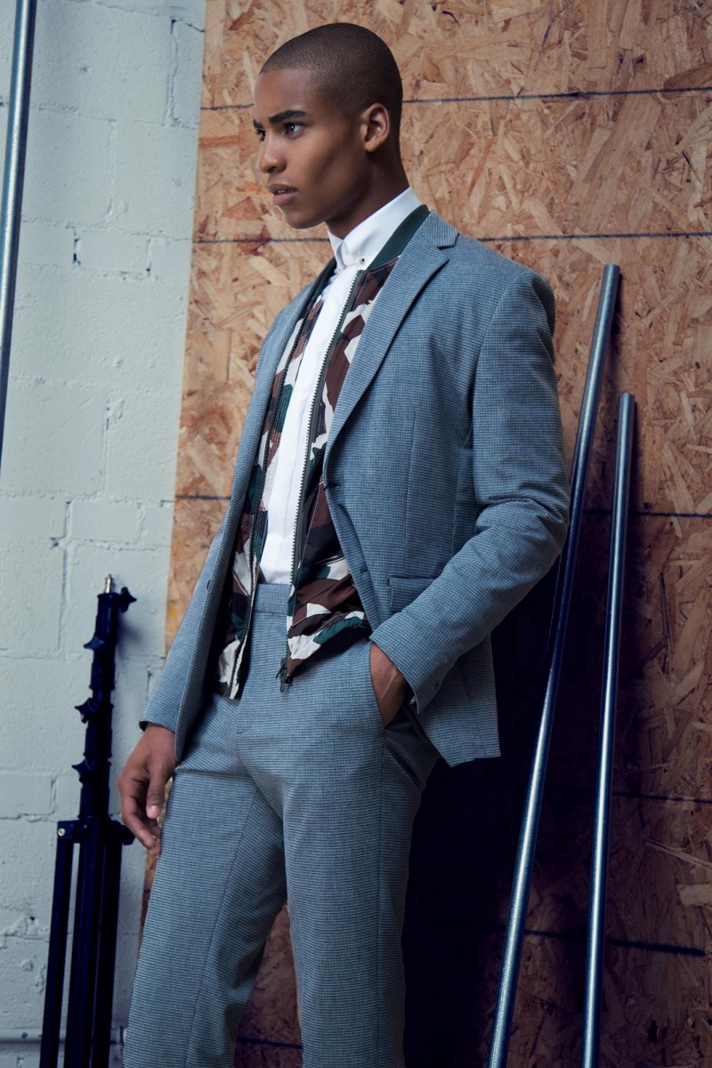 Malik wears suit Theory, bomber jacket Burberry Brit, shirt and collar bar Gian-Paolo Mazzotta.