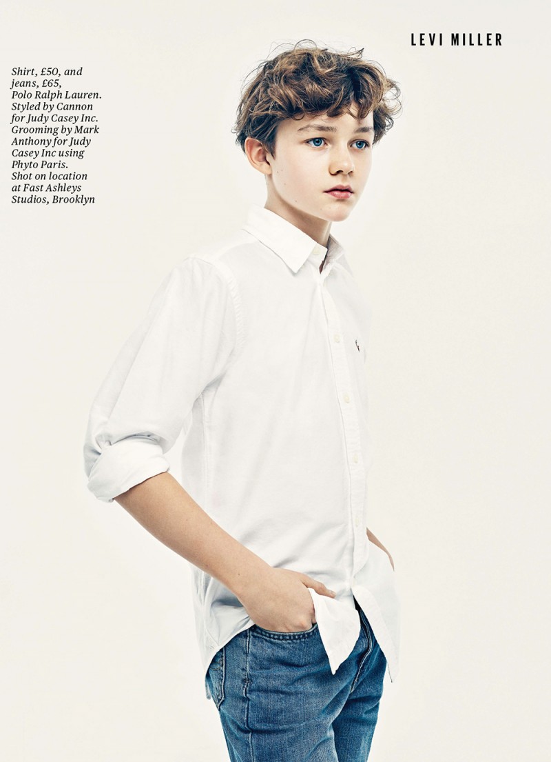 Levi Miller dons a classic white dress shirt with denim jeans.