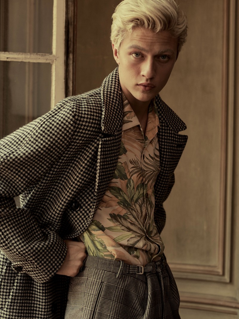 Lucky Blue Smith dons a Tom Ford houndstooth coat with trousers from Jil Sander.