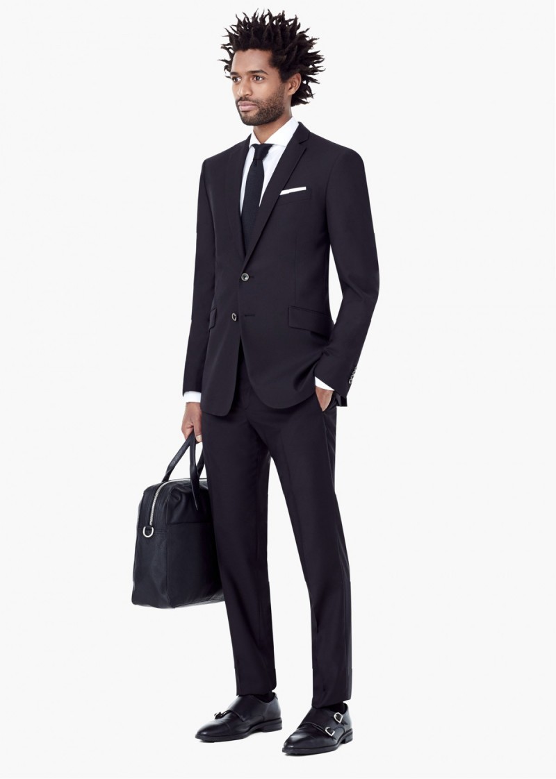 Men's Modern Slim-Fit Suiting: Model Thiago Santos wears Mango's Basilia suit. "This Basilia suit model features narrower lapels than the other suits in this family. It has slanted flap pockets and a tapered trouser which gives you a modern and sophisticated look."