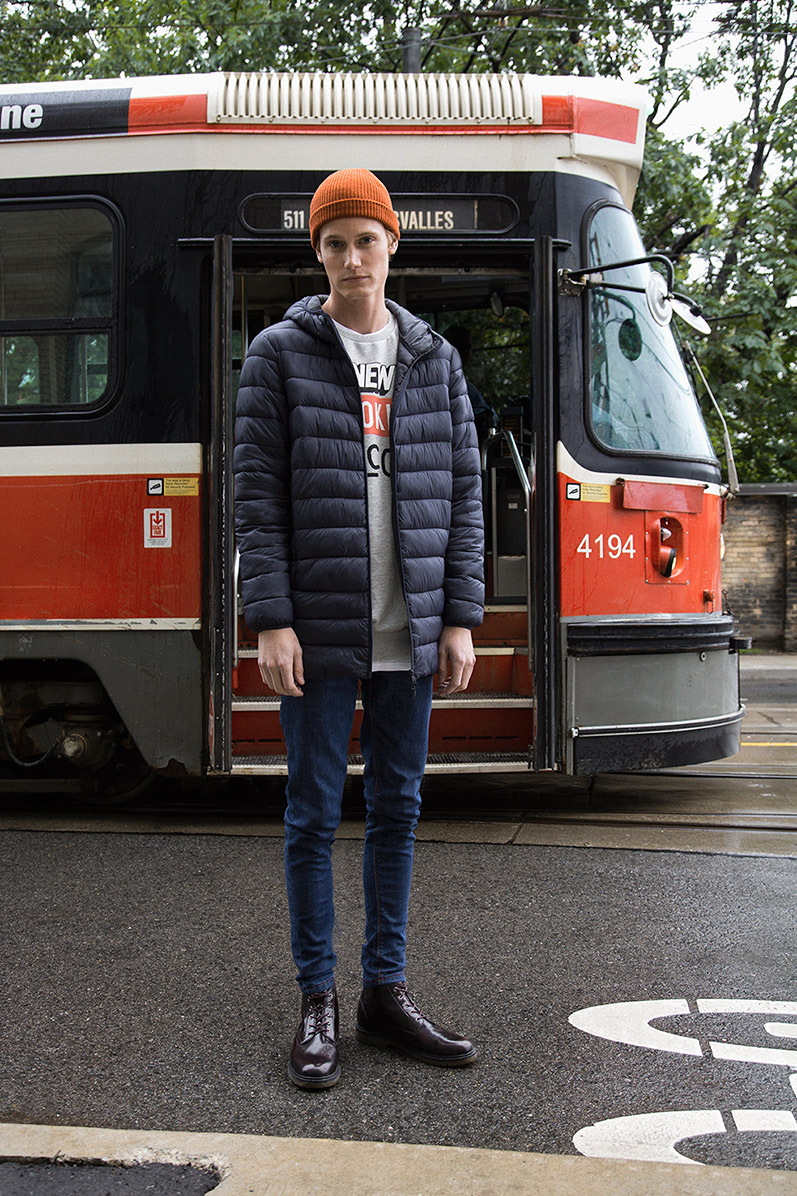 Malcolm De Ruiter goes sporty in a down jacket, paired with a sweatshirt and tapered denim jeans.