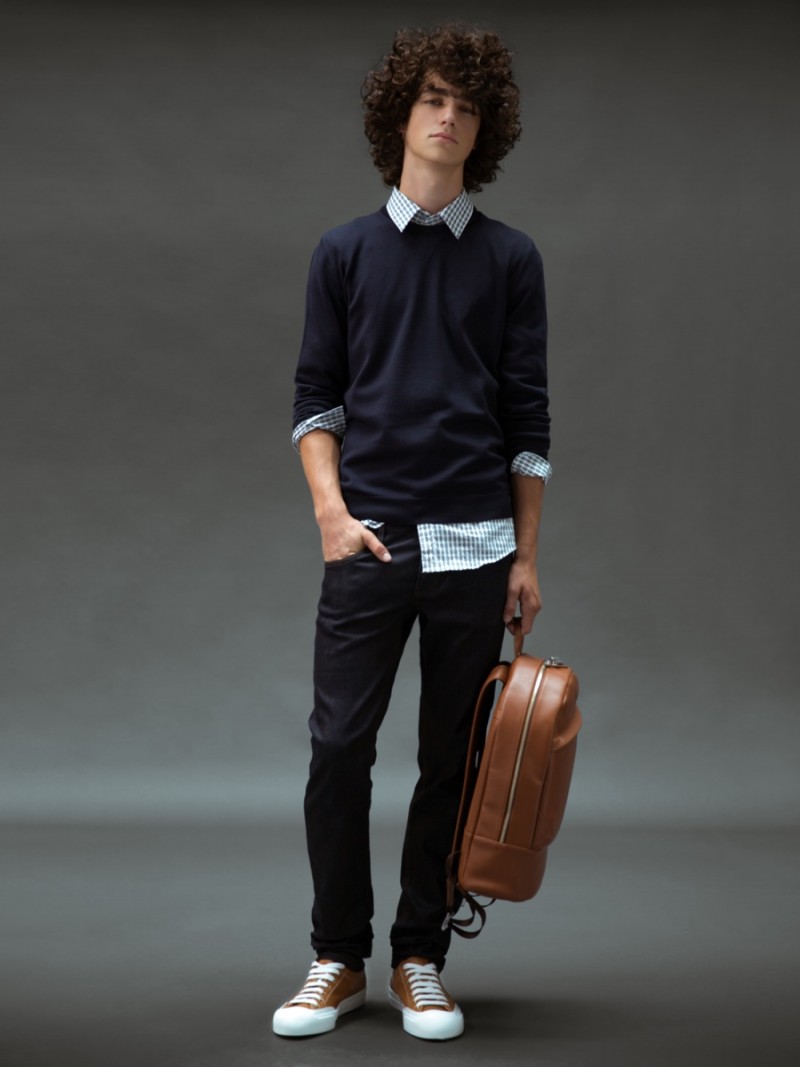 Guy wears backpack WANT Les Essentials de la Vie, shirt, sweater, jeans and shoes Gucci.