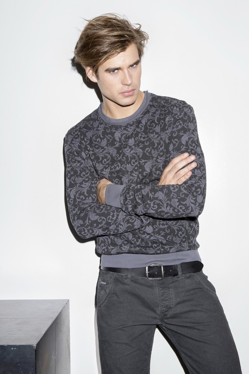 Matt Trethe sports a GUESS brocade print sweatshirt with gray denim jeans.