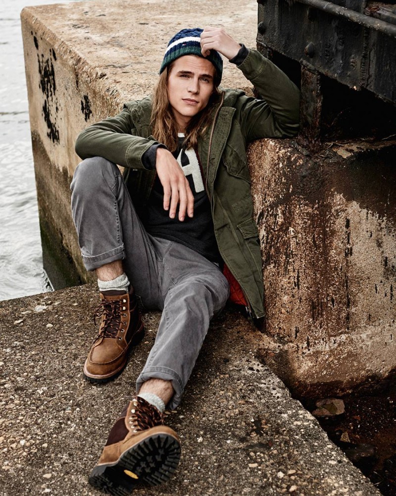 Malcolm Lindberg wears an army green parka and gray denim jeans from Hilfiger Denim's fall 2015 men's collection.