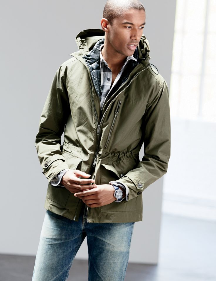 Claudio Monteiro models J.Crew's hooded jacket in olive green.