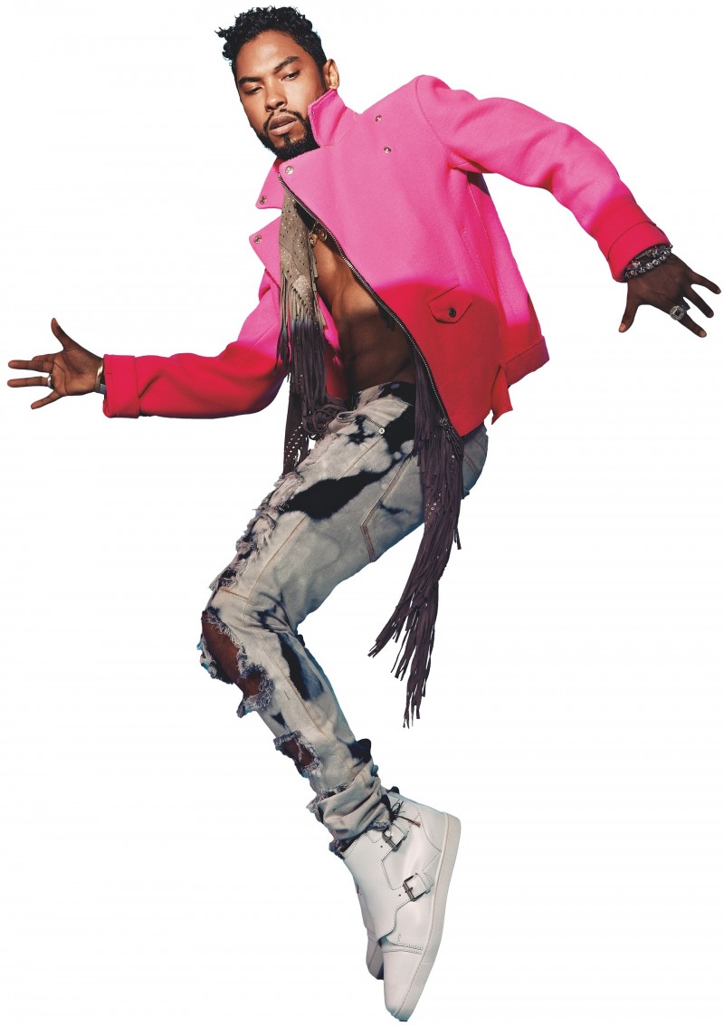 Miguel wears a hot pink wool jacket from Dsquared2 with jeans from Mr Completely and Christian Louboutin white sneakers.