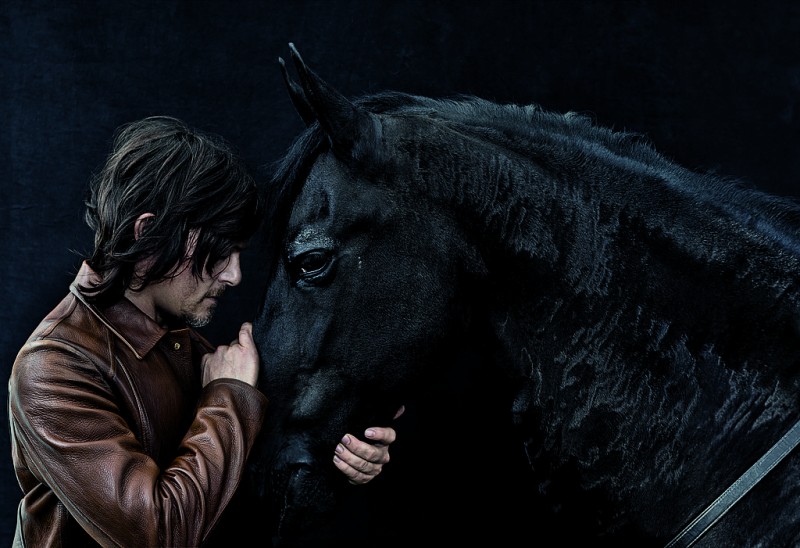Norman Reedus poses with a horse for Details.