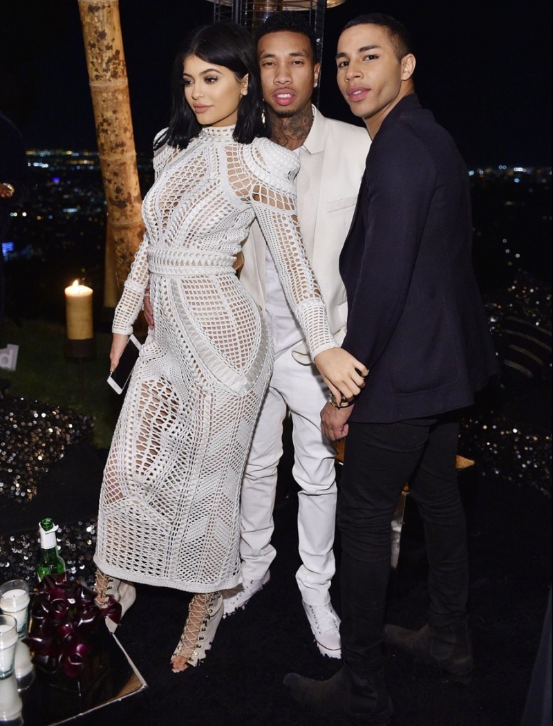 Olivier Rousteing poses for a picture with Kylie Jenner and Tyga.