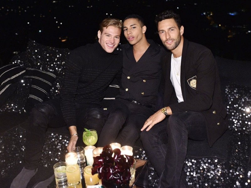 Models Matthew Nozska and Noah Mills join Olivier Rousteing for a picture.