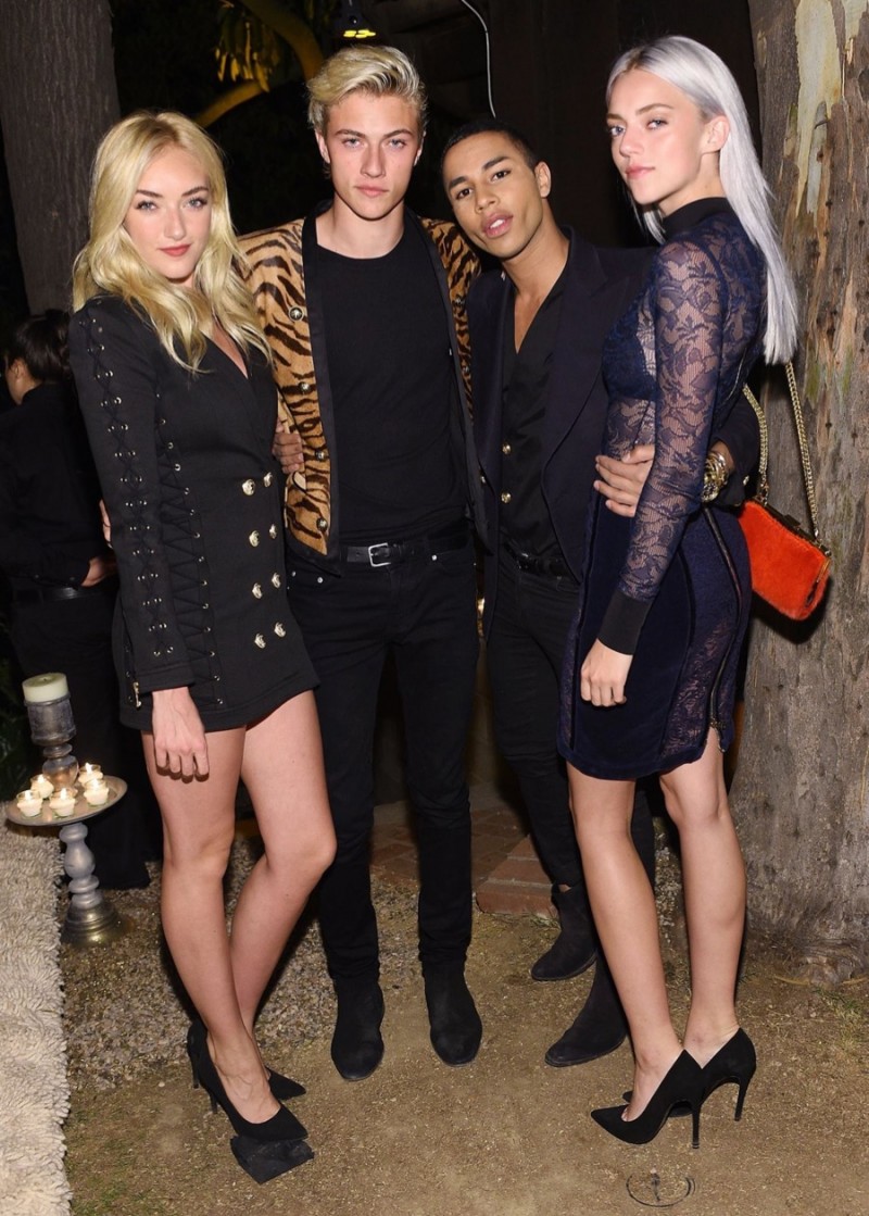 Lucky Blue Smith and his sisters join Olivier Rousteing for a photo.