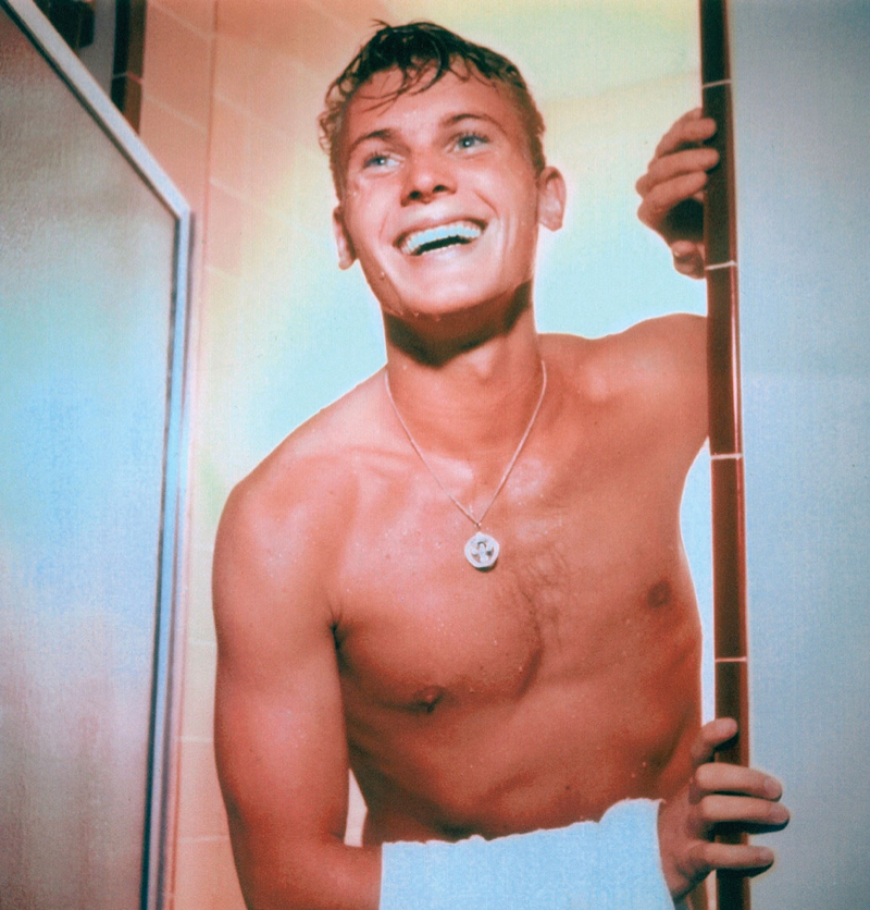 Tab Hunter is all smiles as he appears shirtless in the shower.
