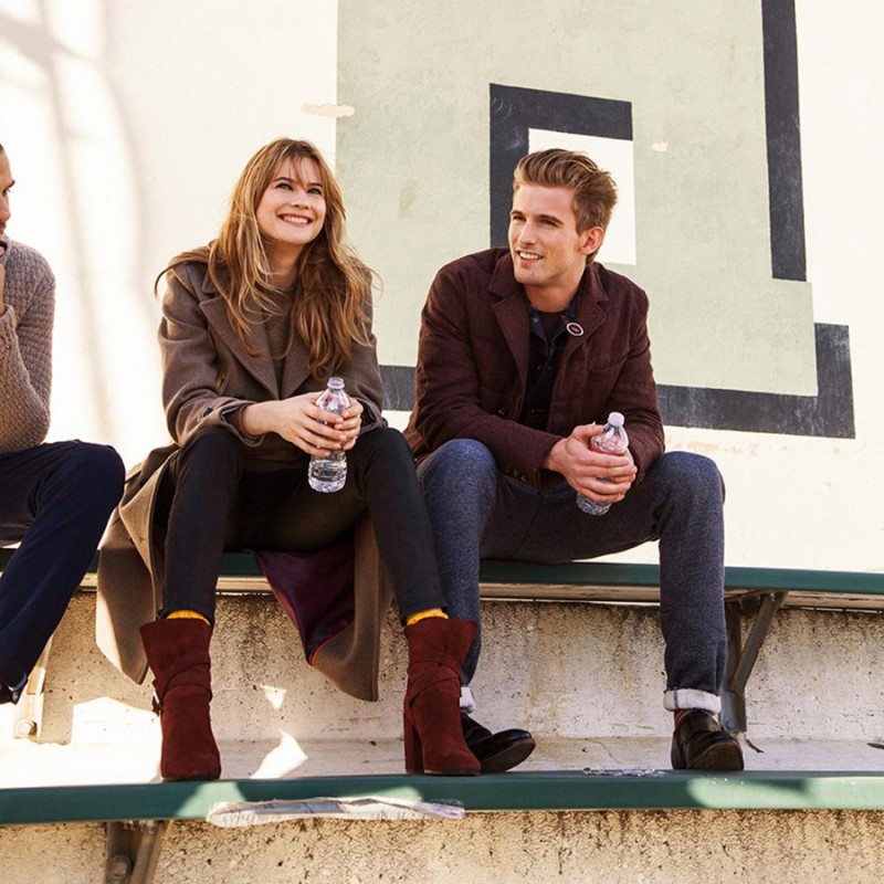 RJ King joins Behati Prinsloo on the bleachers for a stylish game moment from Tommy Hilfiger.