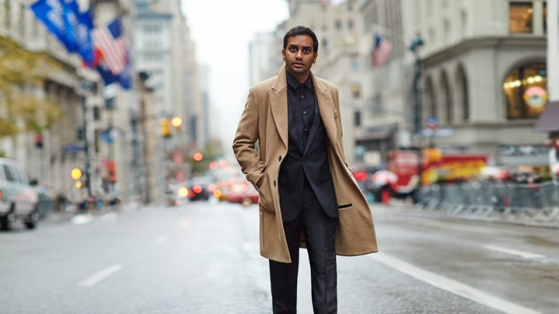 Aziz Ansari wears cashmere overcoat Hardy Amies, tuxedo jacket Saint Laurent, trousers Alexander McQueen and shirt Gucci.