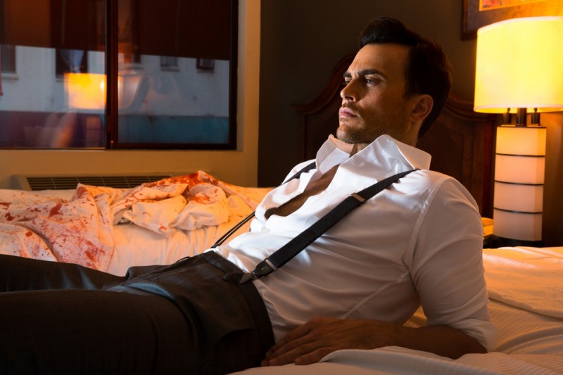 Cheyenne Jackson relaxes on a bed for his Nylon photo shoot.