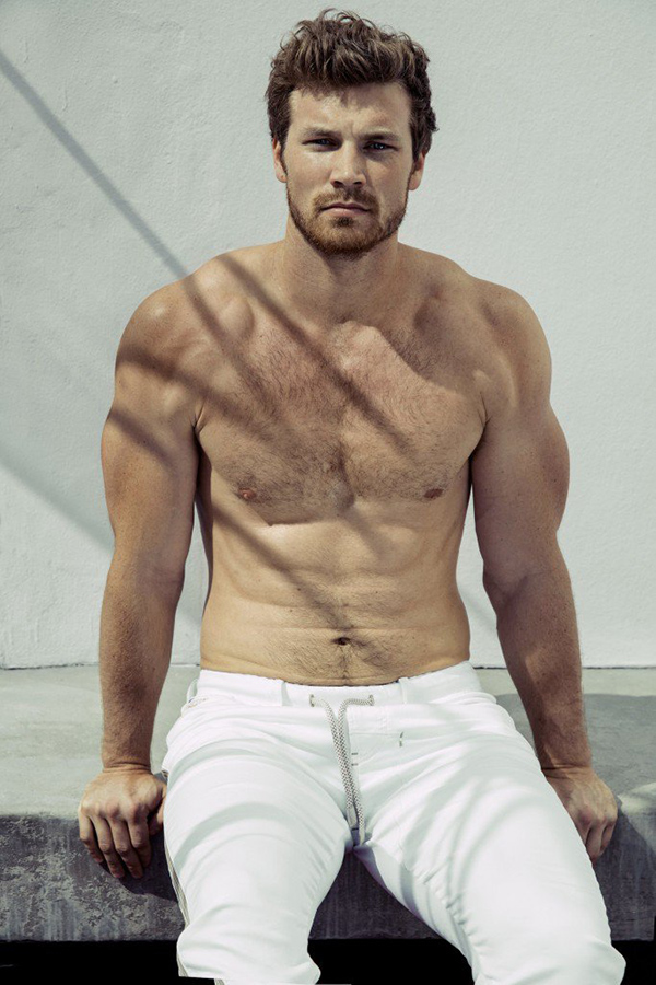 Derek Theler reveals his six-pack as he poses shirtless.