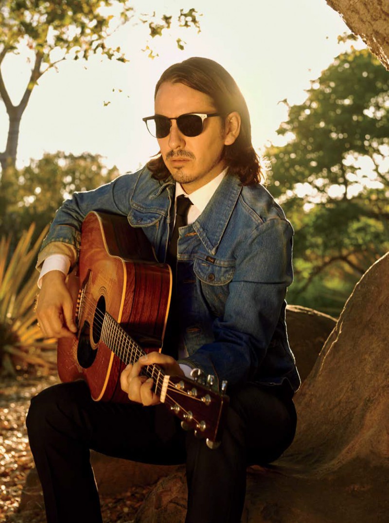 Playing his guitar, Dhani Harrison wears Oliver Peoples Spelman sunglasses.