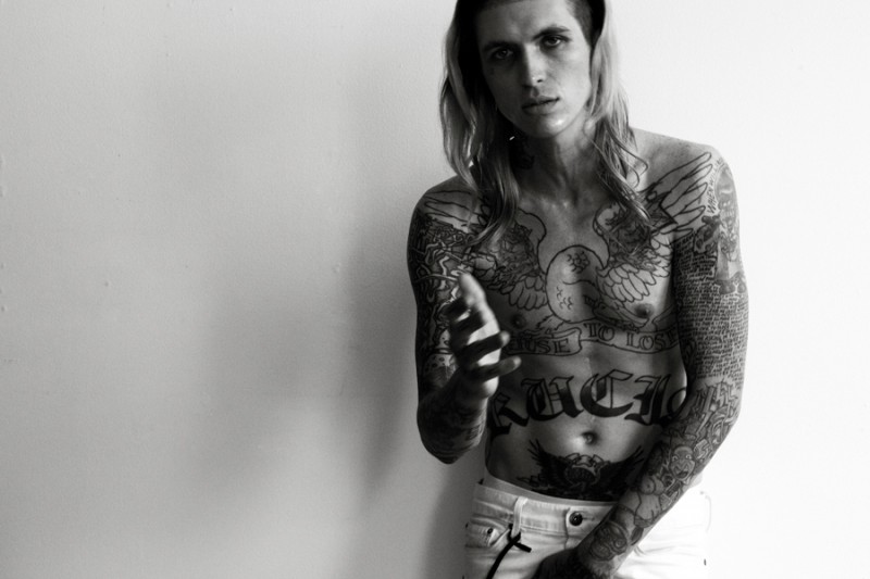 Bradley Soileau goes shirtless, showing off his many tattoos.