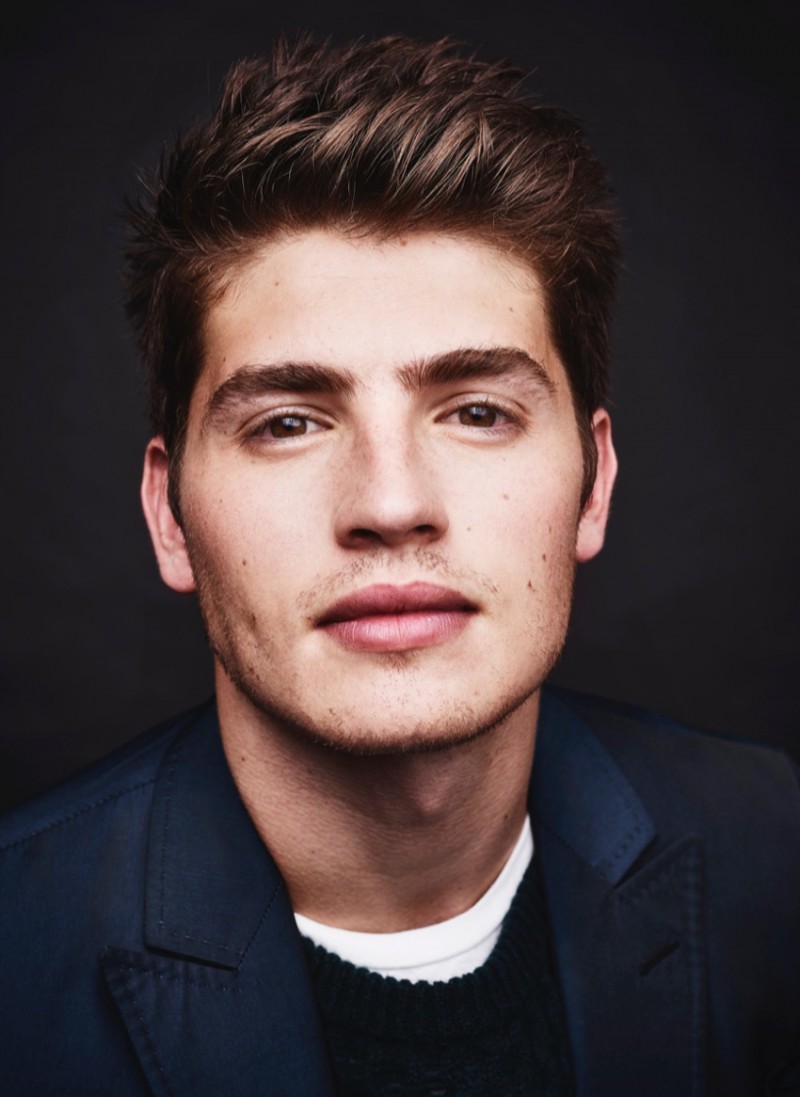 Gregg Sulkin wears suit Valentino, t-shirt Acne Studios and pullover Burberry.