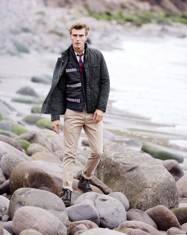 Clément wears J.Crew men’s Sussex quilted jacket, Fair Isle cardigan sweater, slim vintage oxford shirt in white, tie in red tartan, Wallace & Barnes chino in Italian twill and Alden® for J.Crew wing tip boots in green suede. 