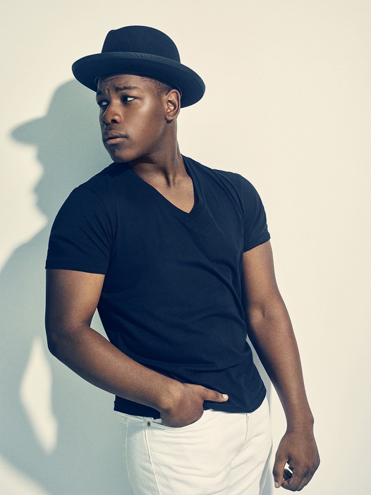 John Boyega plays it casual in a v-neck and fedora hat.