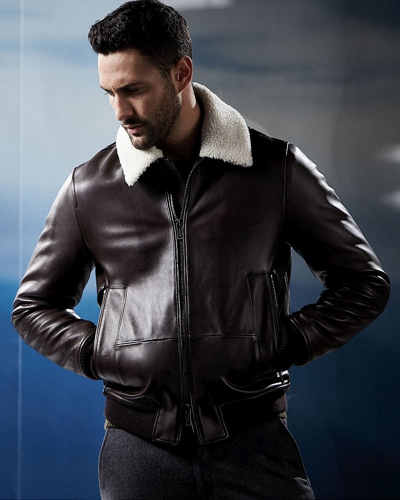Noah Mills wears leather jacket with shearling collar Michael Kors.