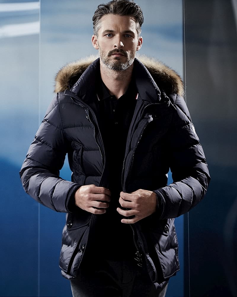 Ben Hill wears nylon quilted puffer jacket with fur hood Moncler.