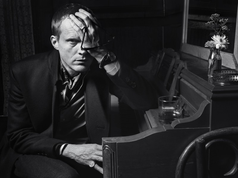 Paul Bettany sports a Prada coat over a Louis Vuitton suit and Ermenegildo Zegna Couture shirt.