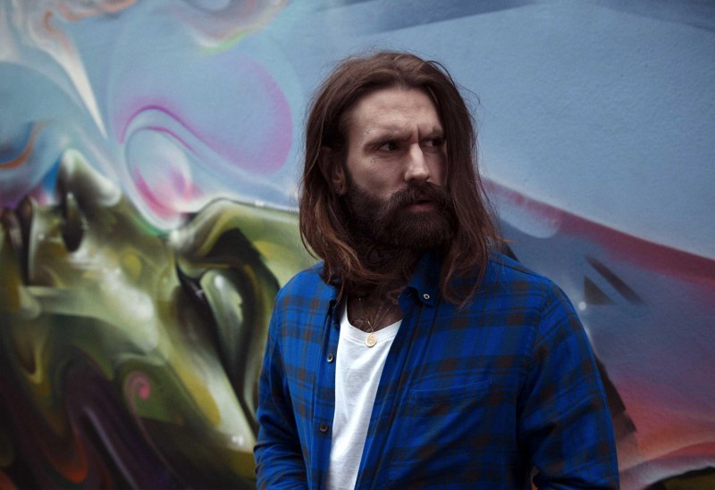 Ricki Hall wears white t-shirt American Vintage and shirt Mads Norgaard Copenhagen.